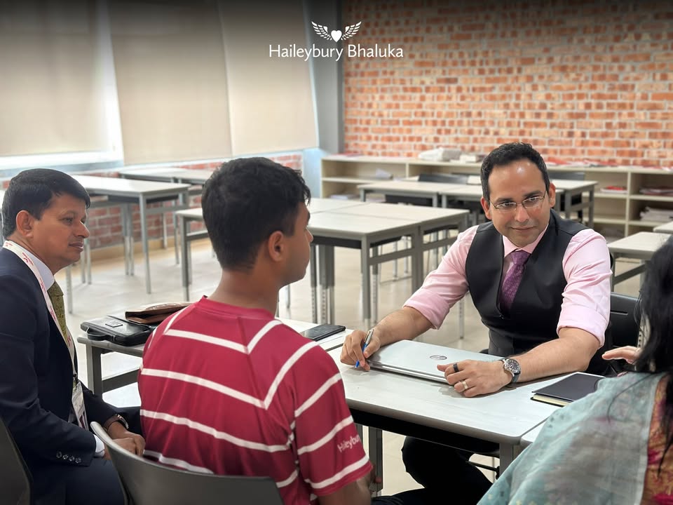 Parents, teachers, and students sharing Iftar dinner during a Parent–Teacher Meeting at Haileybury Bhaluka