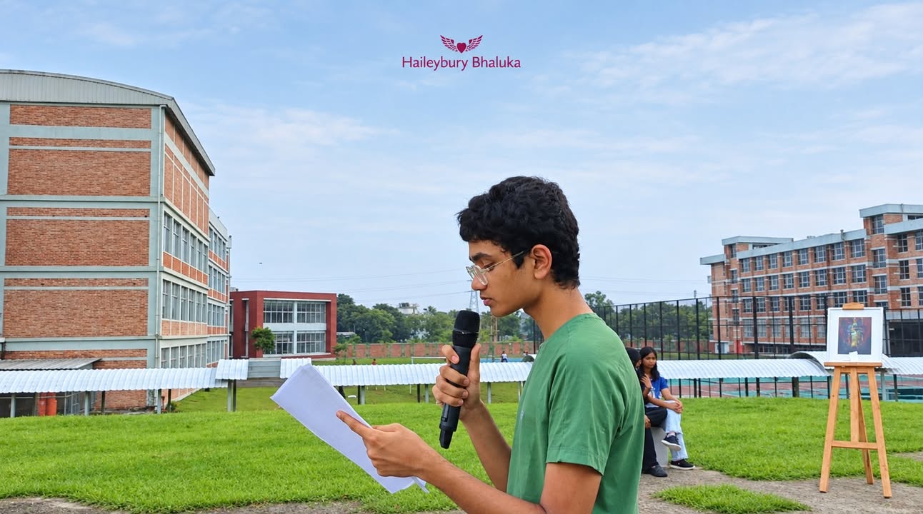 Students reciting poetry outdoors at Haileybury Bhaluka during sunset